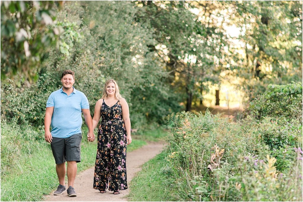 Engaged couple walking on a nature trail