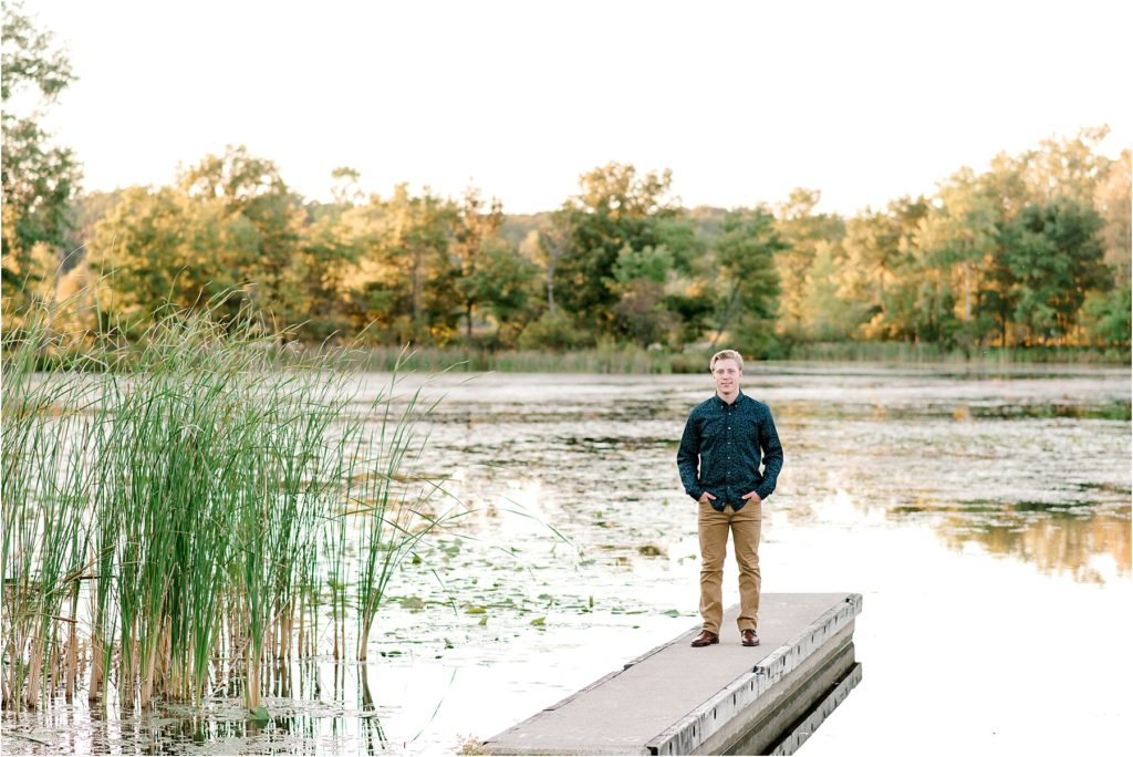 Senior Photo of a young man standing on a dock at Kensington Metropark in Milford, Mi.