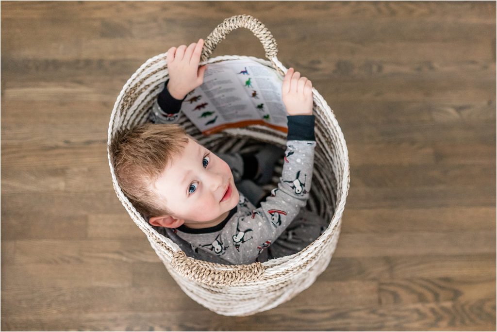 photo of a kid sitting in a basket