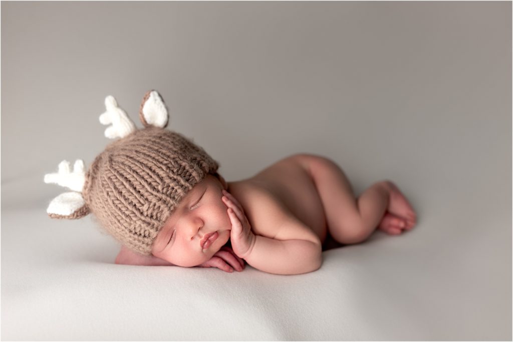 Newborn Portrait Session, baby with deer hat on.