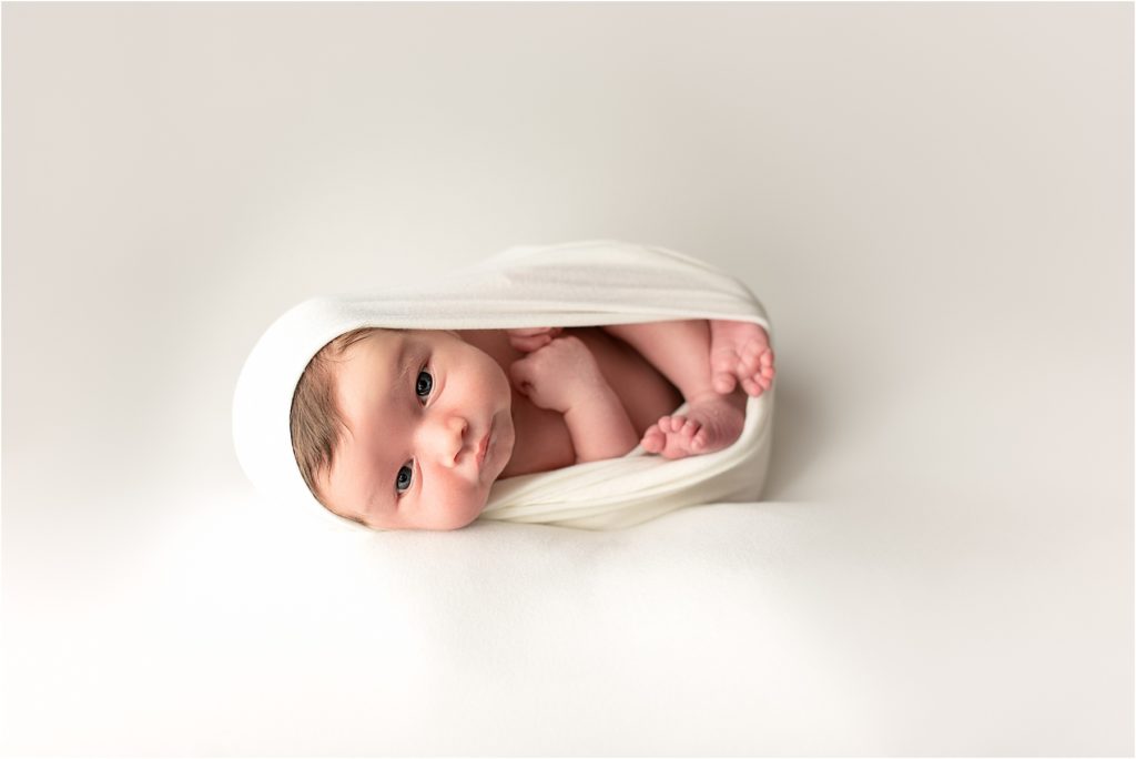 Newborn Portrait, baby looking at the camera.