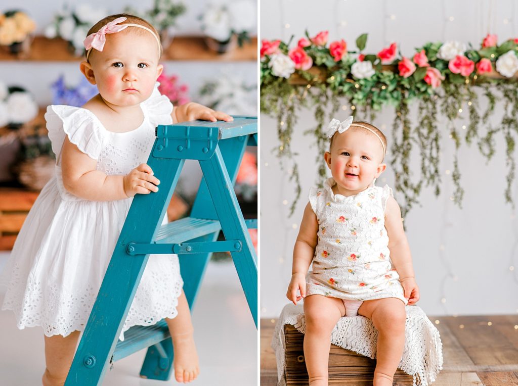 Baby standing at a blue ladder, and sitting in front of a floral backdrop.
