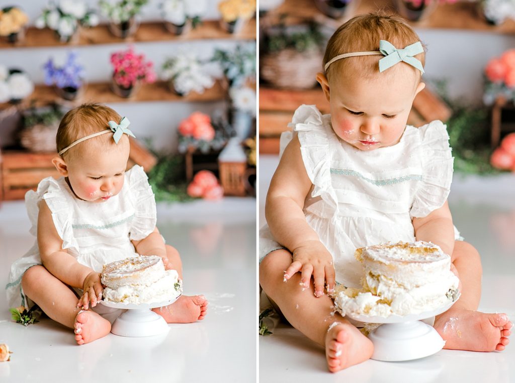 Baby eating cake at her first birthday floral cake smash photo shoot