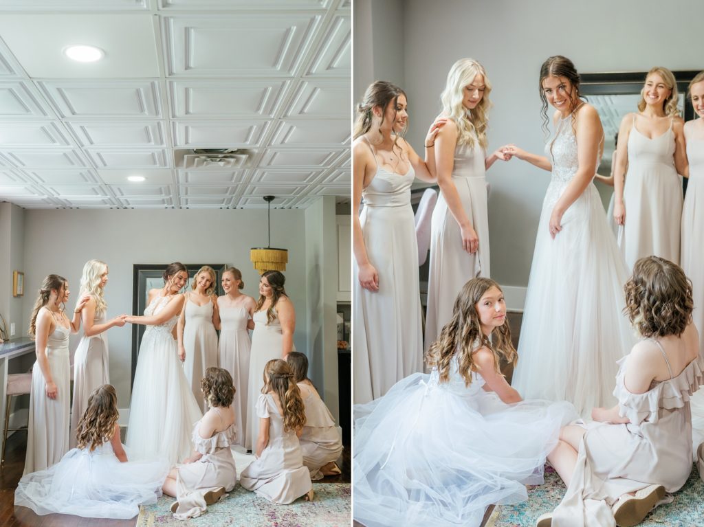 Bridesmaids helping bride adjust her gown at Venue One Eleven Wedding Michigan