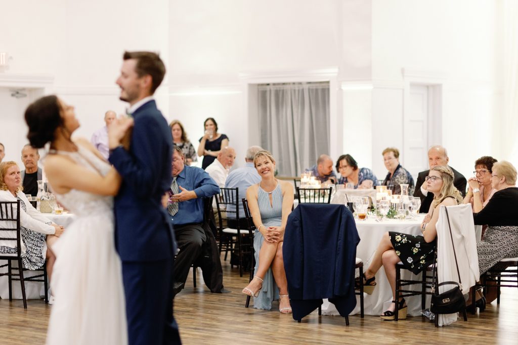 Mother of the groom smiling during couples first dance