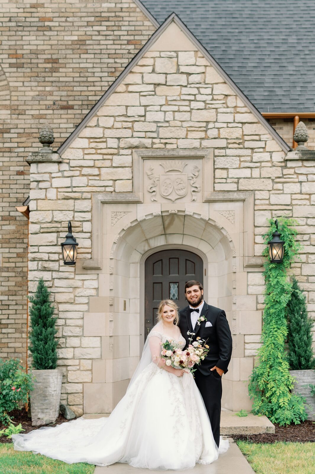 Bride and Groom standing together in a classic side-by-side wedding pose in front of Venue 3Two in Grand Rapids, MI