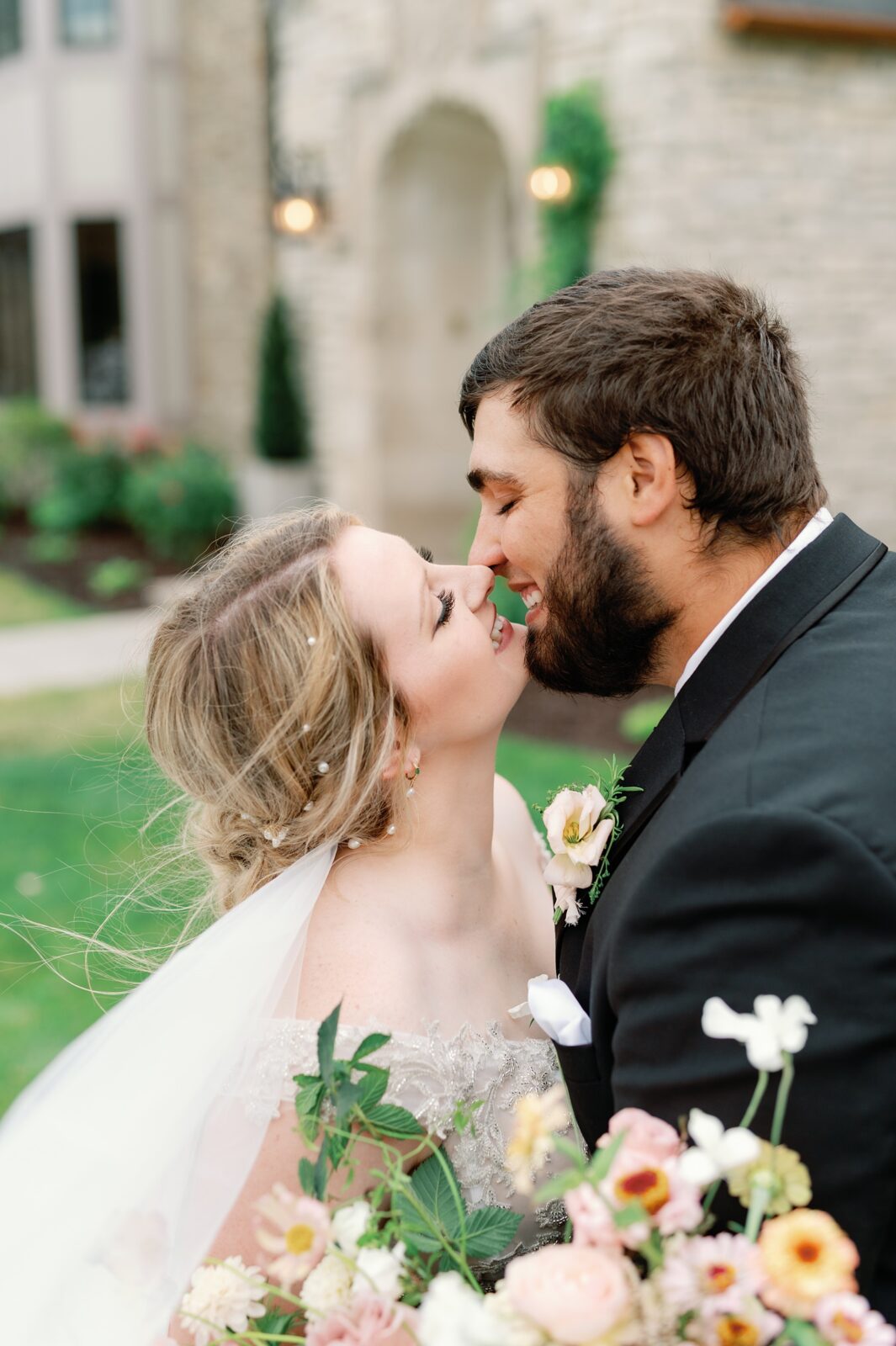 Up close portrait of bride and groom embracing in front of Venue 3Two in Grand Rapids, MI.
