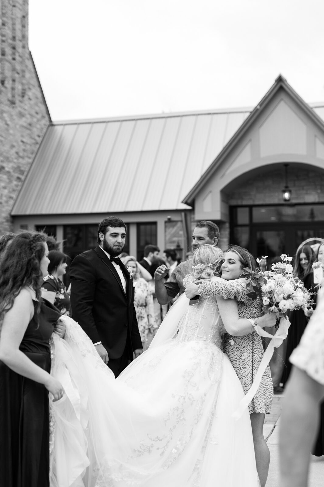 Bride hugging a guest goodbye at the end of the wedding day.