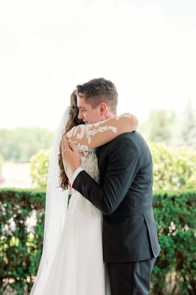 Bride and groom embracing at Greystone Golf Club for their wedding