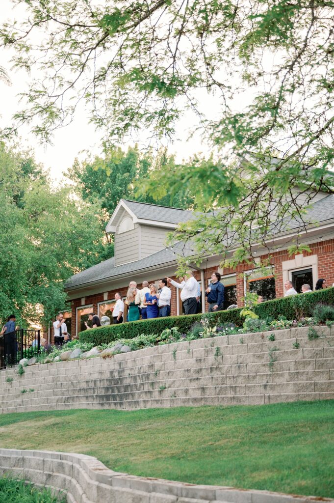 Guests standing on the patio of Greystone Golf Club