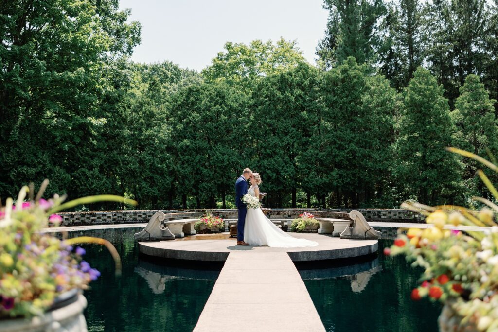 Bride and groom at the water garden at their Felt Mansion Wedding