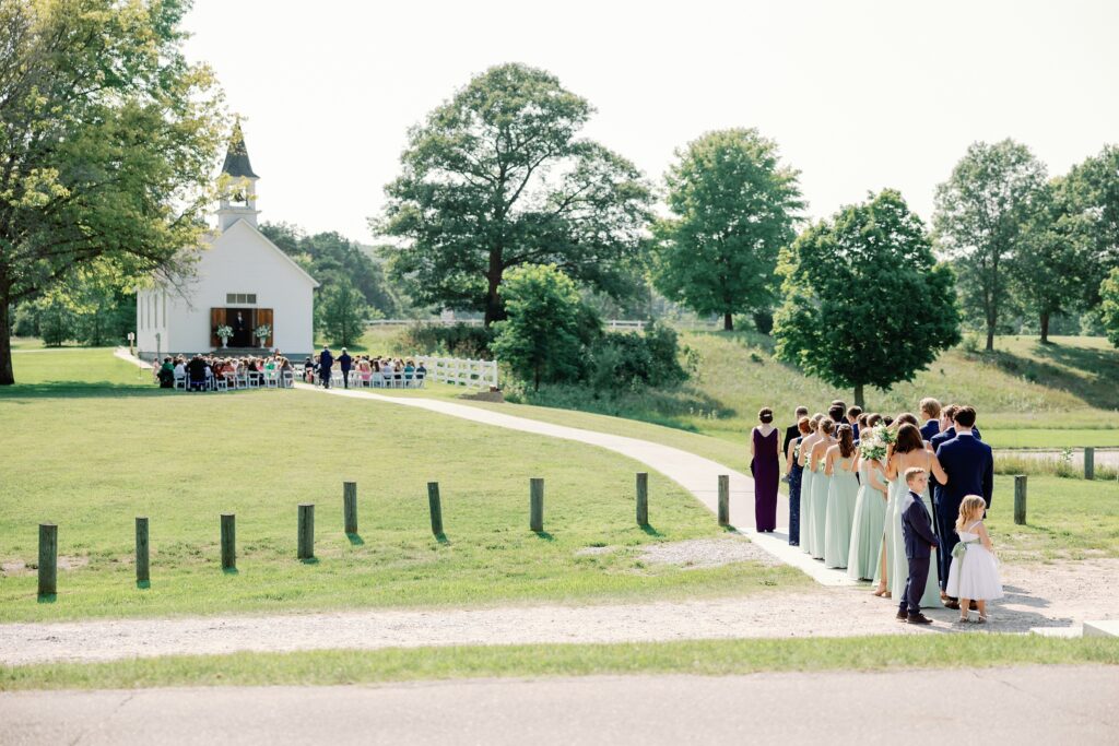 Bridal party lined up in front of the wedding chapel at the felt mansion 