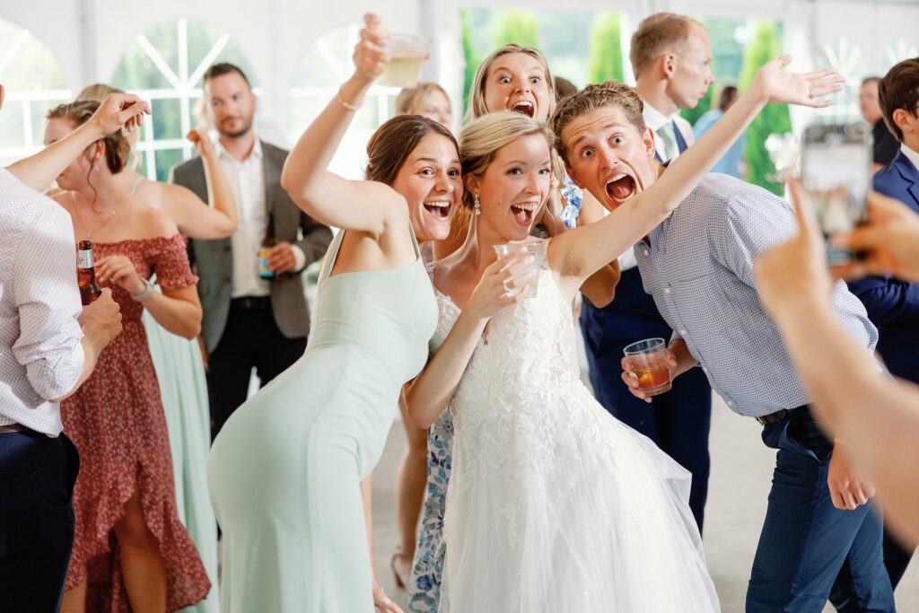 Bride taking a selfie with friends at her wedding reception