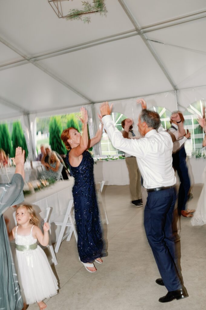 parents of the bride dancing in a fun blurry photo