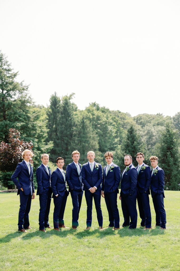 Groomsmen standing in a line with the groom