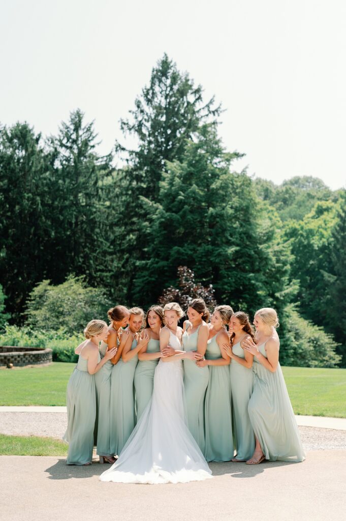 bride with her bridesmaids hugging