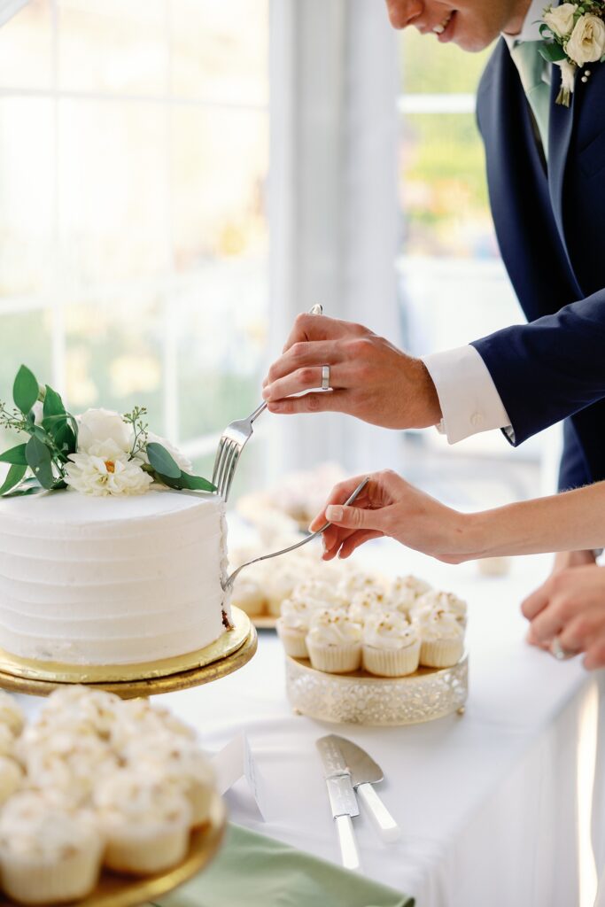 bride and groom cutting their wedding cake together