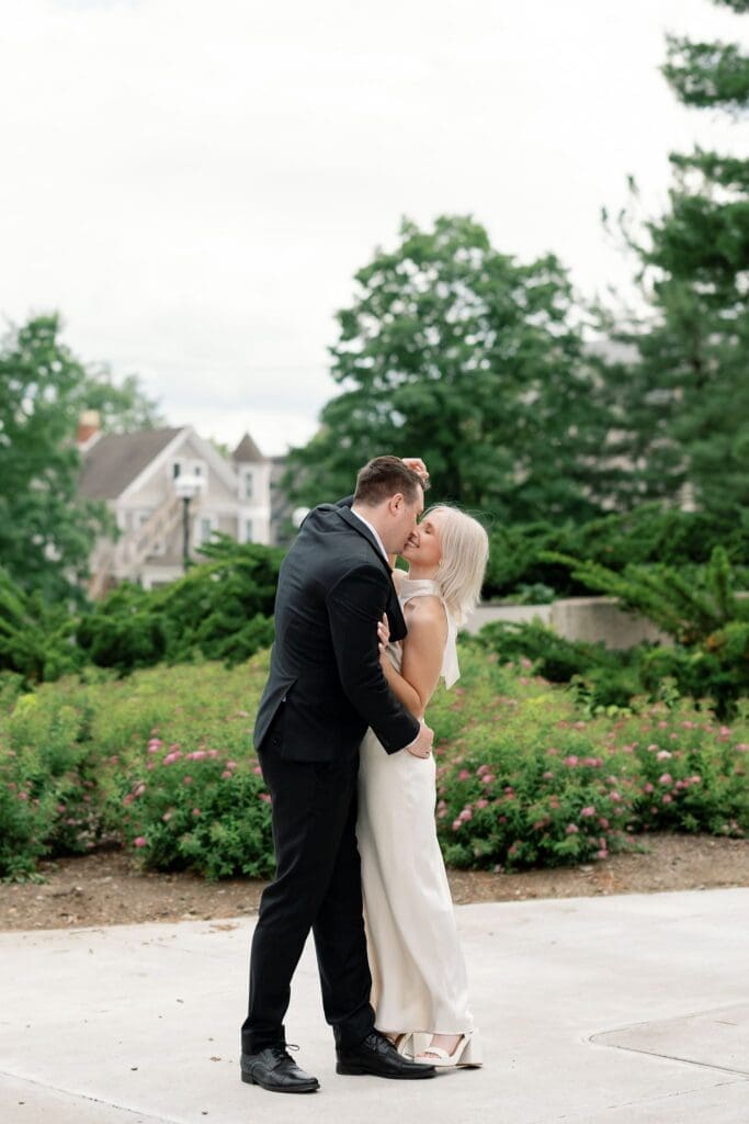 A couple sharing a kiss near a lamppost outside the Law Quad