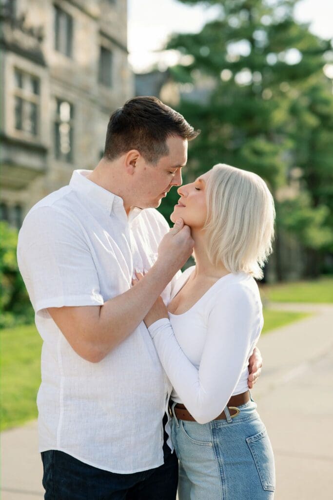 A couple sharing a close, tender moment outdoors during their Ann Arbor engagement session