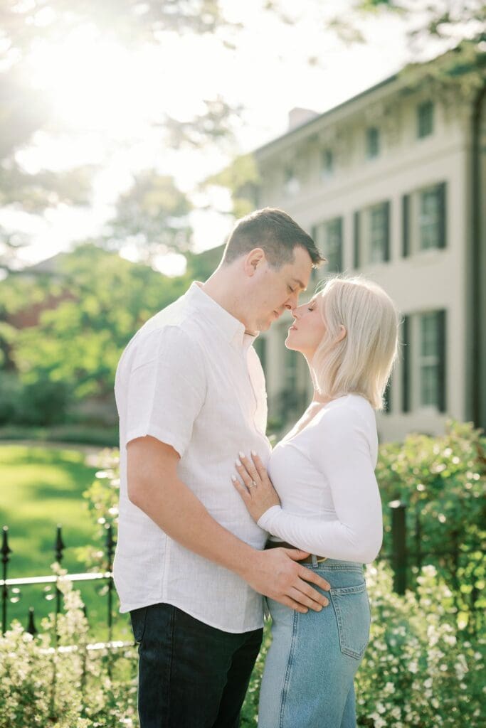 A sunlit close-up of a couple resting foreheads together, Ann Arbor engagement photographer